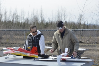 Darcy and Tom checking gear before flight.